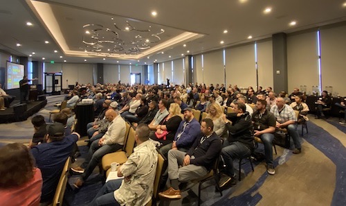 AutoVitals' Employees listening to speaker.